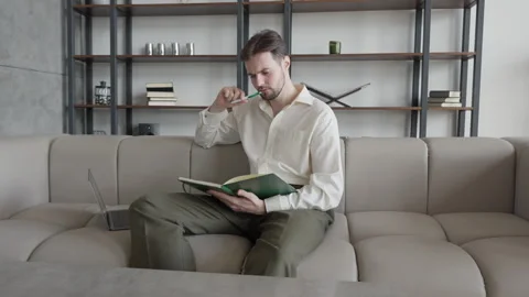 Man Journaling Thoughts into Notebook in Office 스톡 동영상 298184352