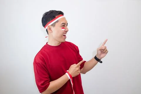 Man With Joyful Smile Pointing To The Side In Nationalist Mood, Celebrating.. Stock Photos