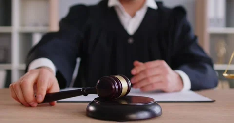 Man judge knocking gavel having court verdict sitting at the desk on workplace Stock Footage 333138944