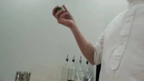 A man juggles green limes in the kitchen. Slow motion Stock Footage 131545792