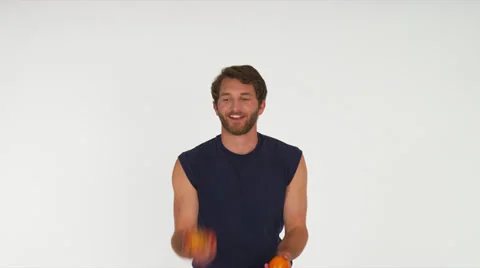Man Juggling Fruit, White Background Stock Footage 35229152