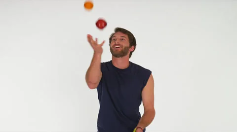 Man Juggling Fruit, White Background Stock Footage 35231360