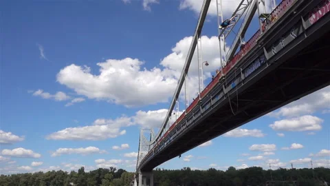 Man jump from a bridge on a cable in slow motion Stock Footage 135532377