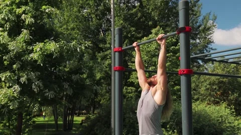 Man jump up to the horizontal bar and do a backflip 動画素材 147076746