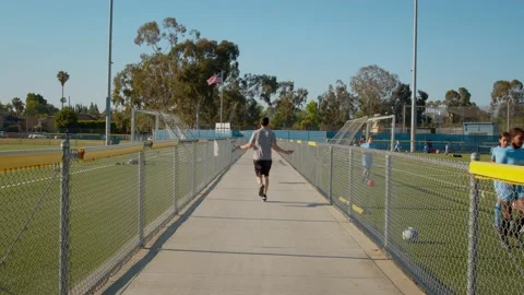 Man jump ropes while running between soccer fields Stock Footage 208957418