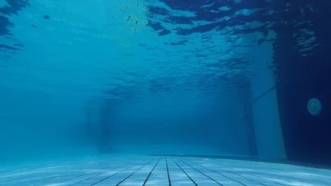 The man jumped over the camera into the pool and swam away. Beautiful shot of Stock Footage 119889570