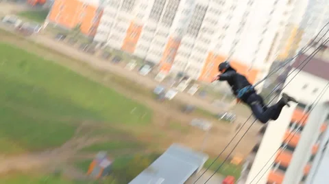 Man jumping from 18 floors high-rise building - shooting at a distance Stock Footage 33387812