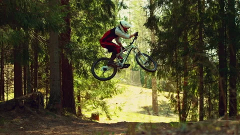 A man jumping in air with mtb in a forest in super slow motion, side view Stock-Footage 146854998