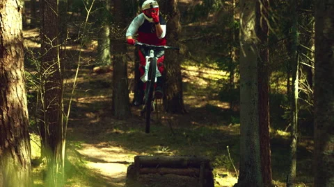 A man jumping in air with mtb in a forest in super slow motion, front view Stock Footage 146855353