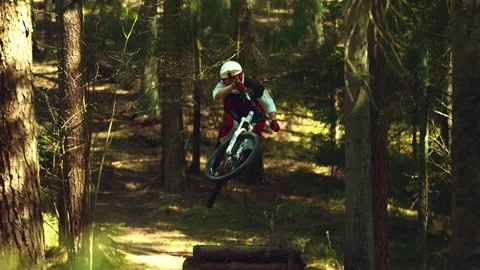 A man jumping in air with mtb in a forest in super slow motion, front view Stock Footage 146857028