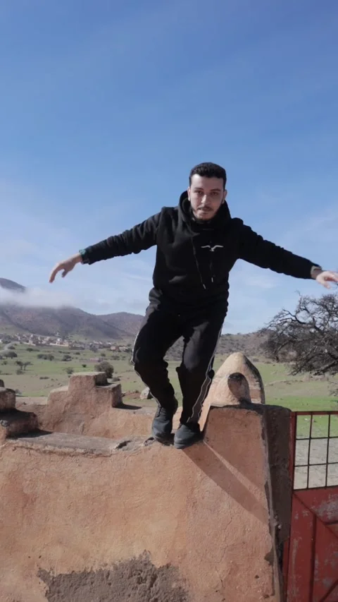 Man Jumping Off Ancient Shrine Wall, Ait Issafen, Morocco Stock Footage 332772681