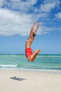 Man jumping on the beach Photos