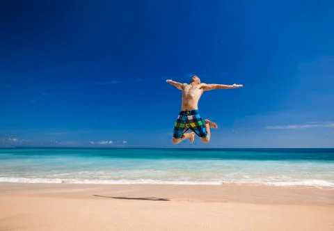 Man jumping on the beach Stock Photos