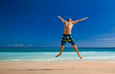 Man jumping on the beach Stock Photos