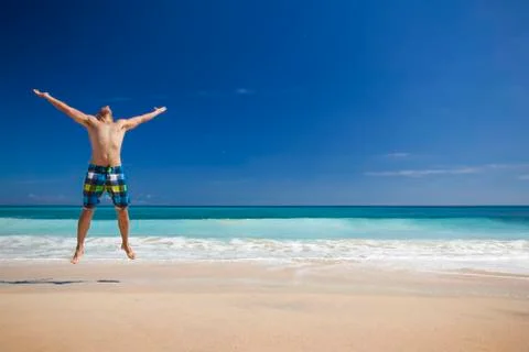 Man jumping on the beach Stock Photos