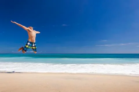 Man jumping on the beach Stock Photos