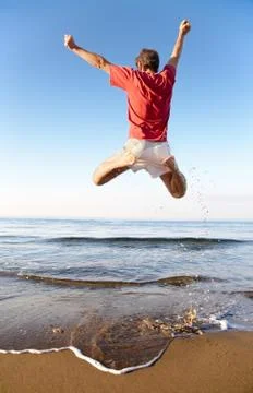 Man jumping on the beach Stock Photos