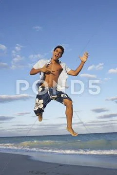 Man Jumping on the Beach Stock Photos