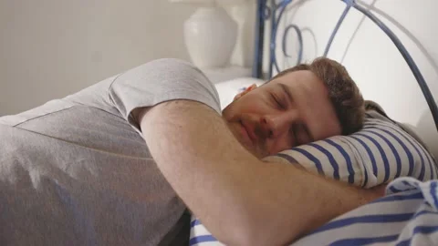 Man Jumping in Bed Resting Relaxing Sleeping Bed Day Time Mental Health Stockbeeldmateriaal 195287507