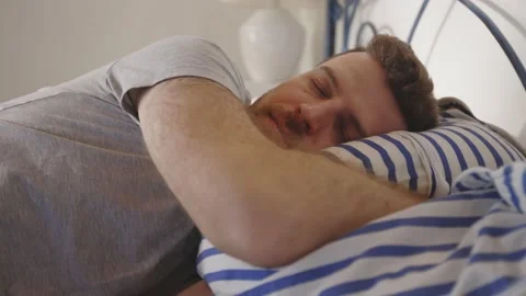 Man Jumping in Bed Resting Relaxing Sleeping Bed Day Time Mental Health Stockbeeldmateriaal 195287517