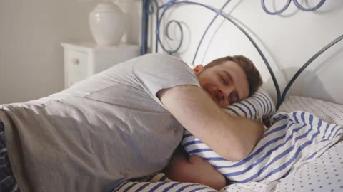 Man Jumping in Bed Resting Relaxing Sleeping Bed Day Time Mental Health Stockbeeldmateriaal 195287521