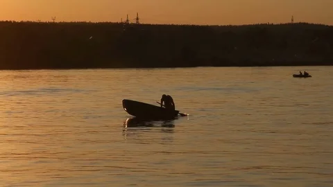 Man jumping from a boat at sunset Stock Footage 83731863