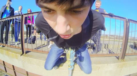 Man jumping from the bridge on the background of the group Stock Footage 52430591