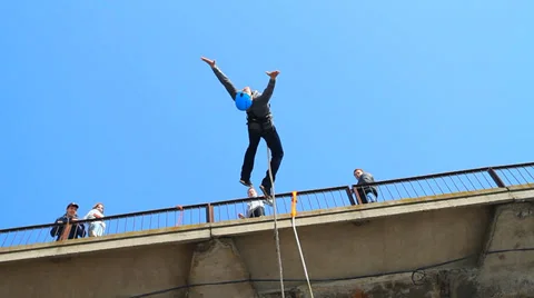 Man jumping off a bridge backwards Stock Footage 37220648