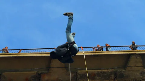 Man jumping off a bridge backwards Stock Footage 37220781