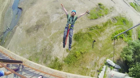 A man jumping off a bridge backwards good rebounding Stock Footage 53349408