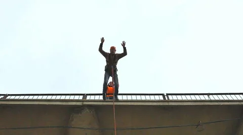 Man jumping from the bridge facing forward Stock Footage 49921384