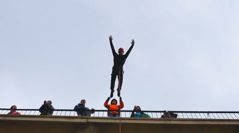 Man jumping from the bridge facing forward with the coup Stock Footage 49921662