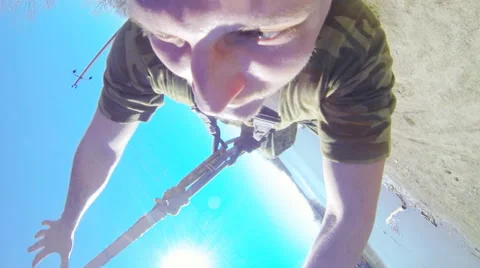 A man jumping from the bridge facing forward sharply Stock Footage 52429300