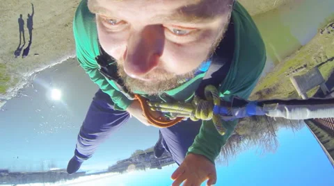 Man jumping from the bridge facing forward rolling over on its side Stock Footage 52429944