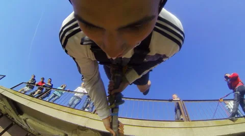 A man jumping from the bridge facing forward holding the rope Stock Footage 52431037