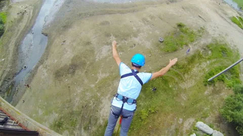 Man jumping from the bridge facing forward strongly rebounding with splayed legs Stock Footage 53349046