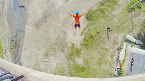 A man jumping from the bridge facing forward in the posture of the crab Stock Footage 53349485