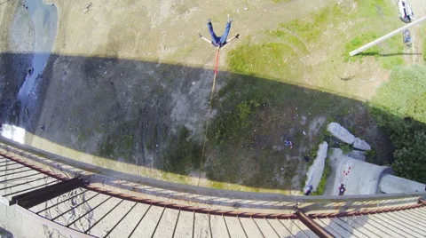 A man jumping from the bridge facing forward Stock Footage 53349649