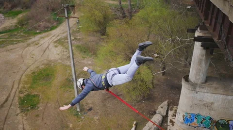 A man jumping from the bridge facing forward Stock Footage 68347757