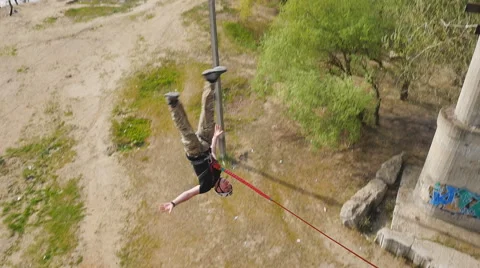 A man jumping from the bridge facing forward with the coup Stock Footage 68350015