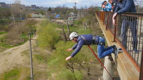 A man jumping from the bridge facing forward with the coup Stock Footage 68352164