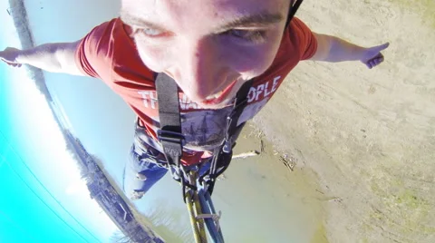 Man jumping from the bridge waving hands facing forward Stock Footage 52428748