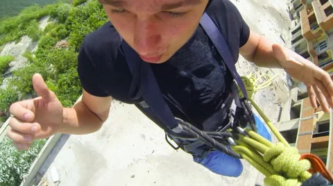 Man jumping facing forward waving Stock Footage 48359621