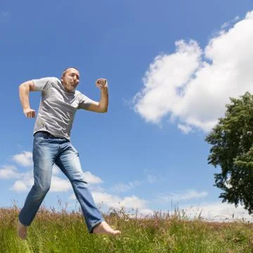 Man is jumping in front of blue sky 写真素材