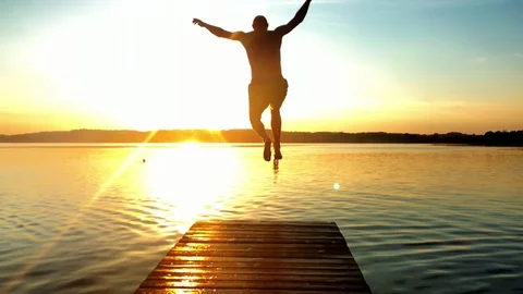 Man jumping into the lake Stock Footage 95390188