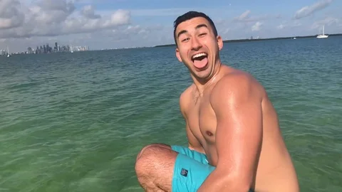 Man Jumping in Ocean from Boat Stock Footage 129053855