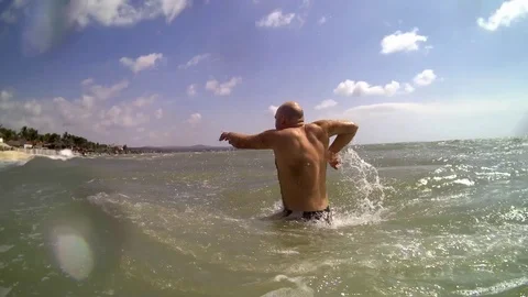 Man jumping into ocean. Stock Footage 99814022