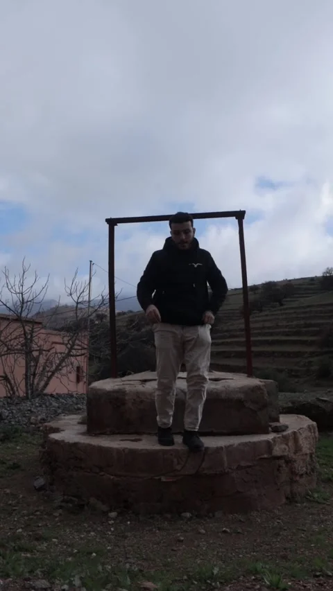 Man Jumping Over Ancient Stone Well in Rural Moroccan Village Stock-Footage 332769581