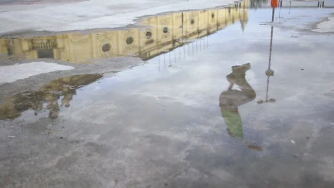 Man jumping over puddle on roller blades, slow motion Stock Footage 146952920