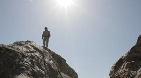 Man jumping over rocks against the sky Video stock 61748774